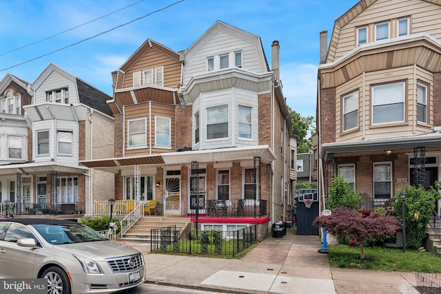 townhome / multi-family property featuring covered porch