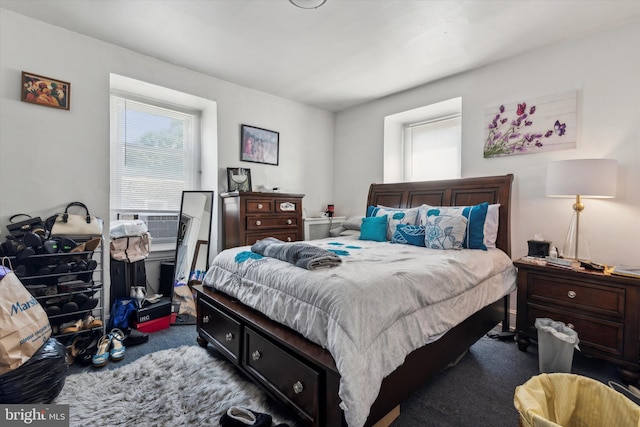 bedroom with cooling unit and dark carpet