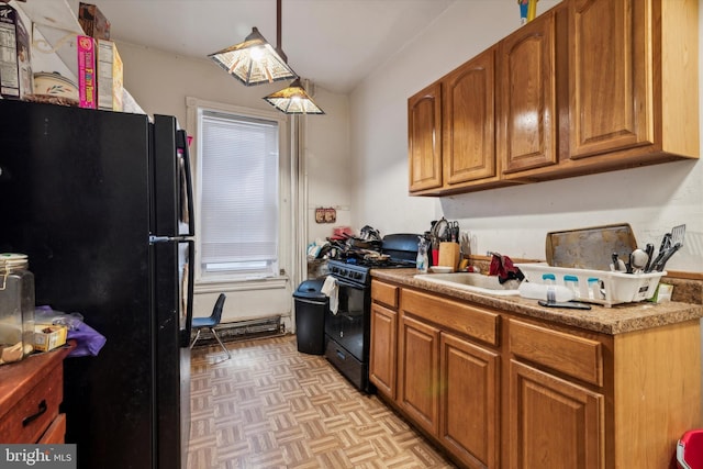 kitchen featuring sink, pendant lighting, light parquet flooring, and black appliances