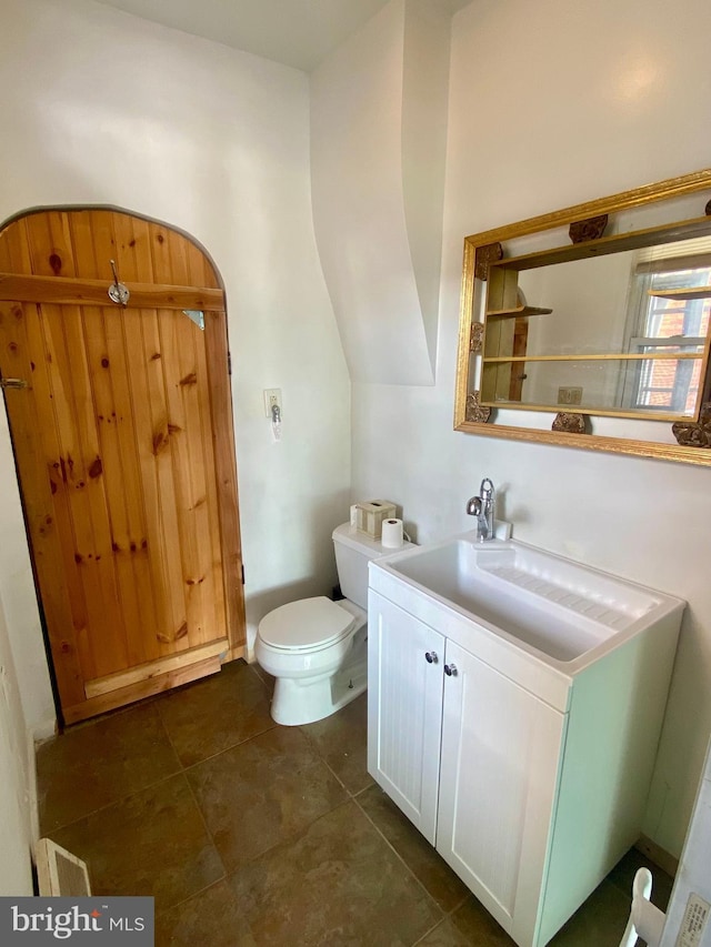 bathroom with vanity, tile patterned floors, and toilet