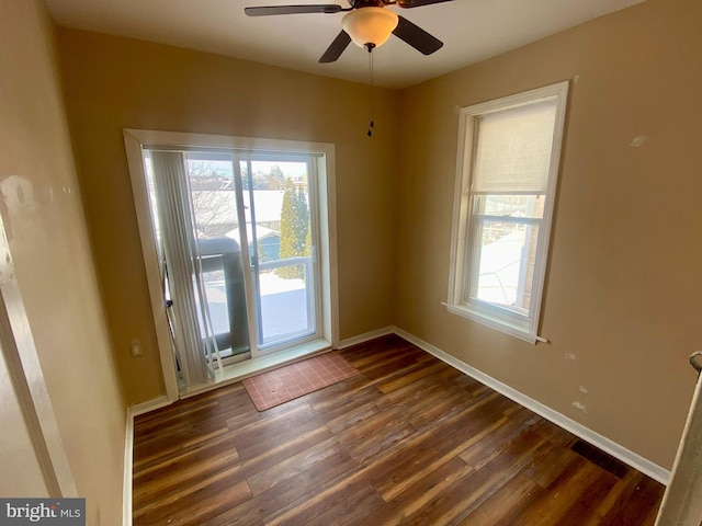 spare room with ceiling fan and dark hardwood / wood-style floors