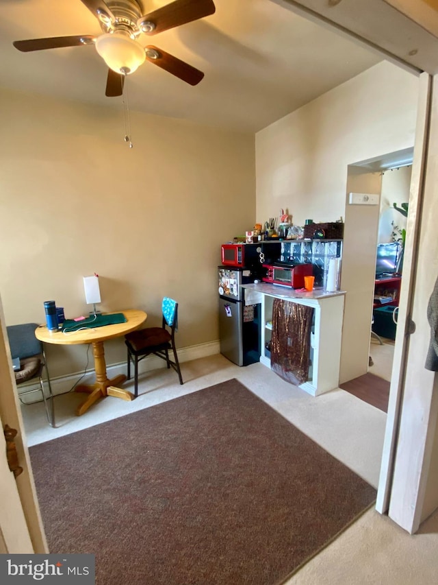 interior space featuring light colored carpet and ceiling fan