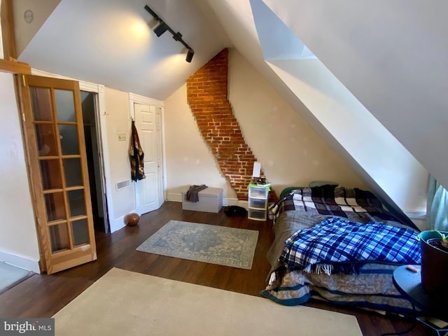 bonus room featuring dark hardwood / wood-style floors and vaulted ceiling