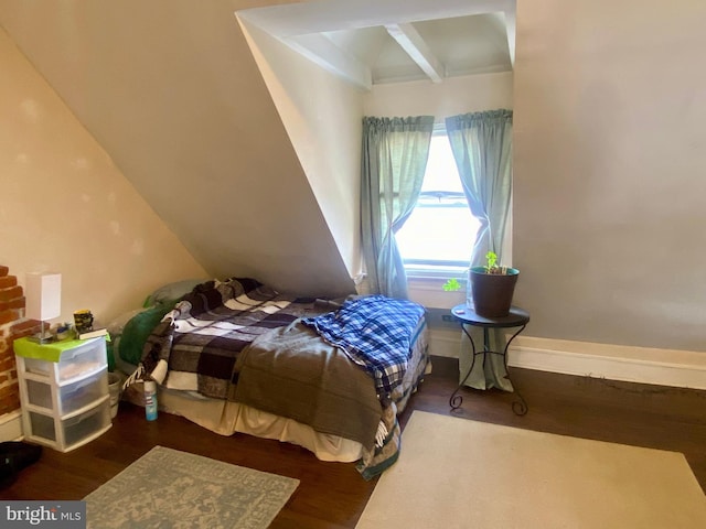 bedroom featuring wood-type flooring and beam ceiling