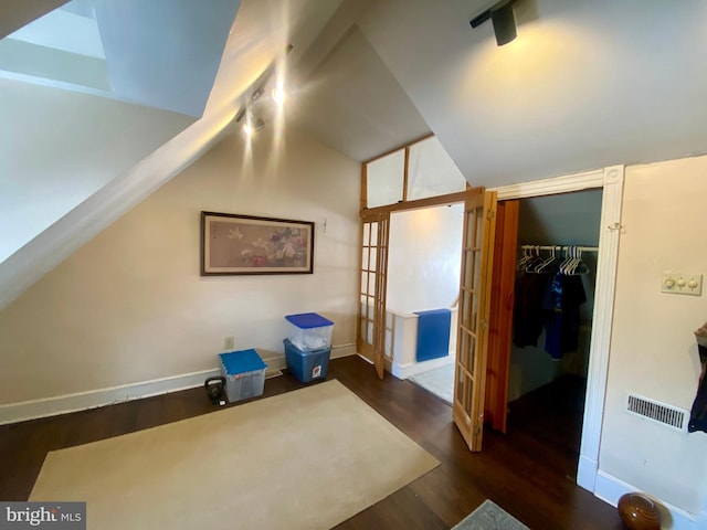 bonus room featuring dark hardwood / wood-style flooring, vaulted ceiling, and french doors