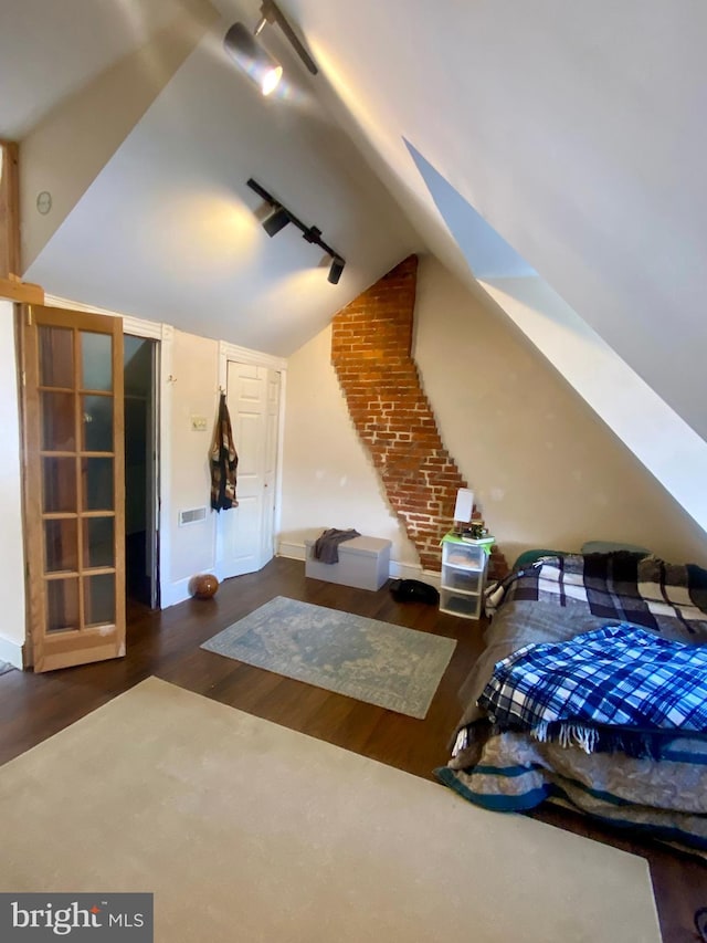 interior space with lofted ceiling and dark hardwood / wood-style flooring