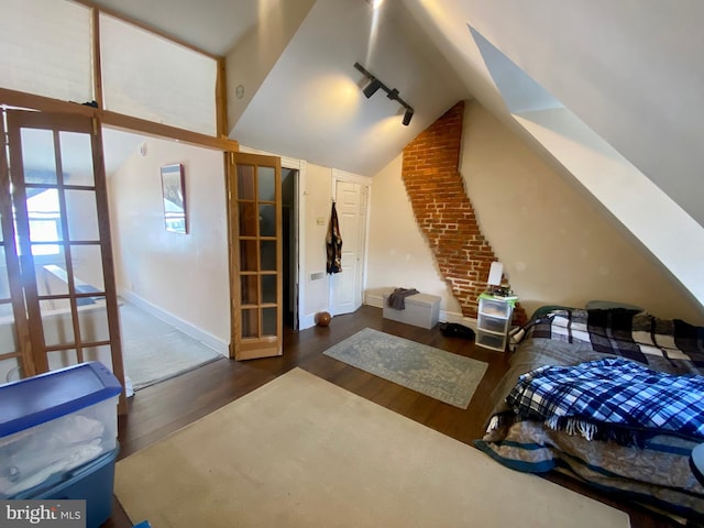 additional living space with dark hardwood / wood-style flooring and vaulted ceiling