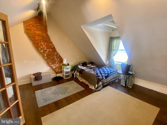 bedroom featuring vaulted ceiling and dark wood-type flooring