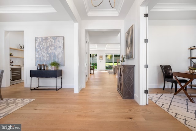 hall with light hardwood / wood-style floors, wine cooler, and ornamental molding