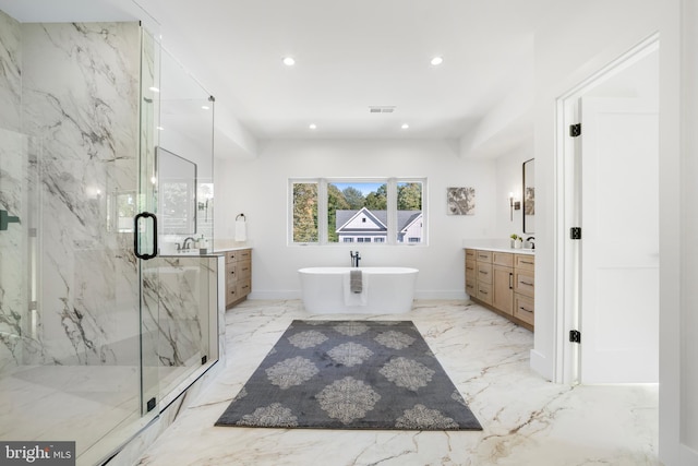 bathroom featuring vanity and independent shower and bath