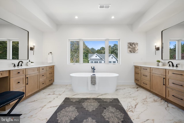 bathroom with vanity and a tub