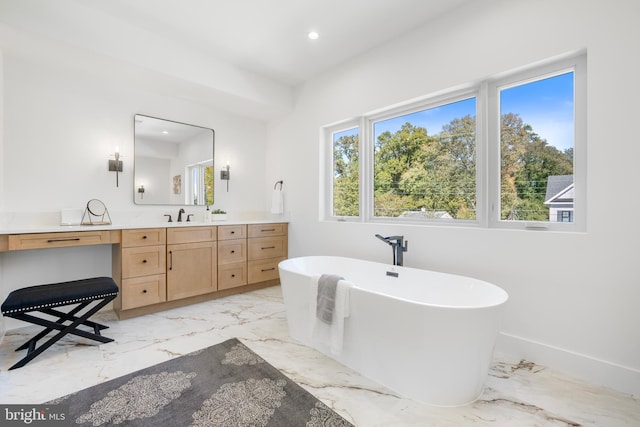 bathroom with vanity and a tub to relax in