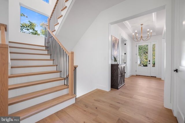 foyer with a notable chandelier and light hardwood / wood-style flooring