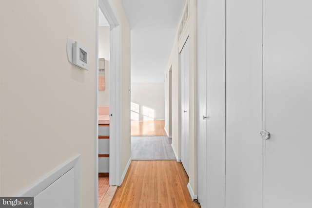 hallway with light hardwood / wood-style floors