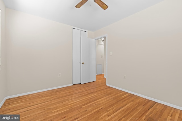 unfurnished bedroom featuring a closet, ceiling fan, and light hardwood / wood-style flooring