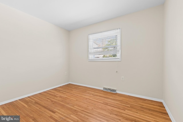 empty room with hardwood / wood-style flooring