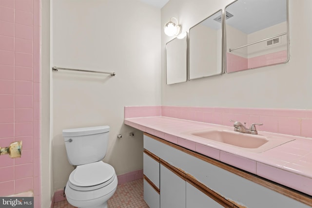 bathroom featuring tile patterned floors, vanity, and toilet