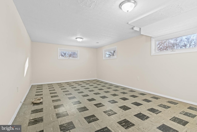 basement featuring a textured ceiling