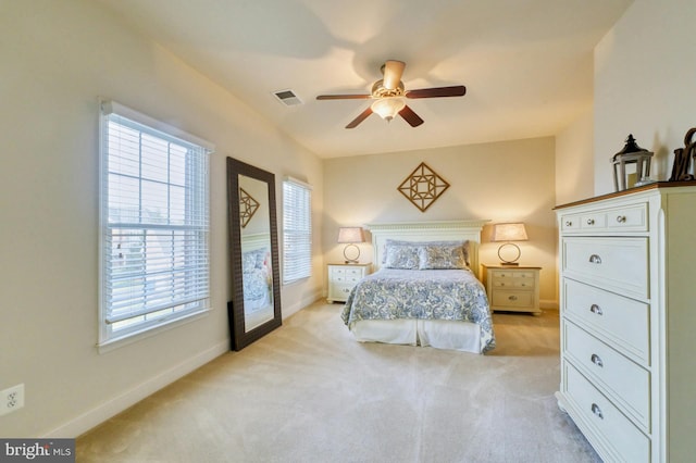 bedroom featuring light carpet and ceiling fan