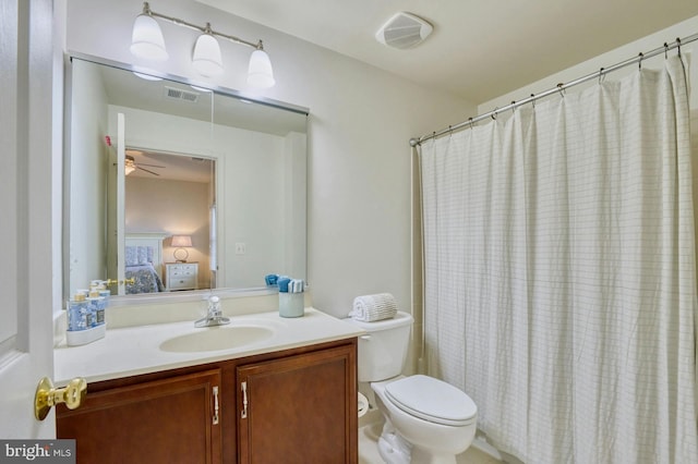 bathroom featuring vanity, toilet, and ceiling fan