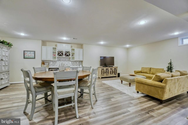 dining space with light hardwood / wood-style flooring