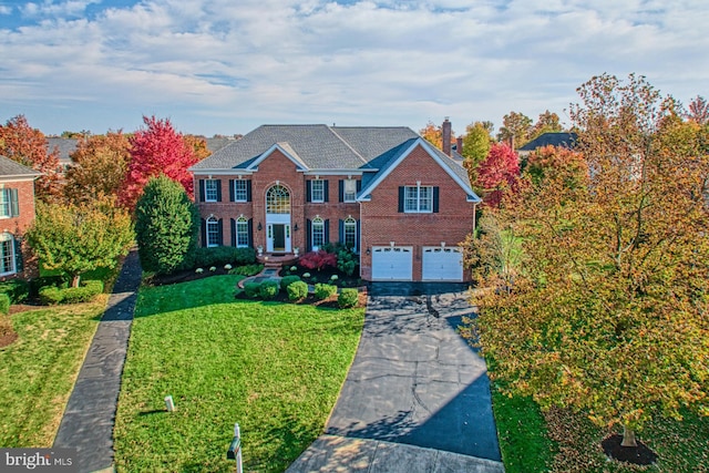 view of front of house featuring a garage and a front lawn