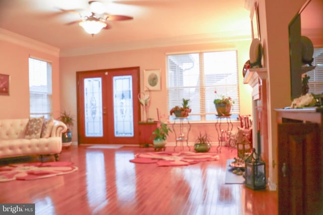 foyer entrance with french doors, ceiling fan, ornamental molding, and wood-type flooring