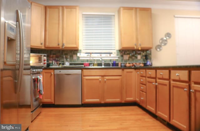 kitchen featuring fridge with ice dispenser, sink, stainless steel dishwasher, decorative backsplash, and light wood-type flooring