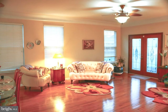 living room featuring crown molding, french doors, ceiling fan, and wood-type flooring