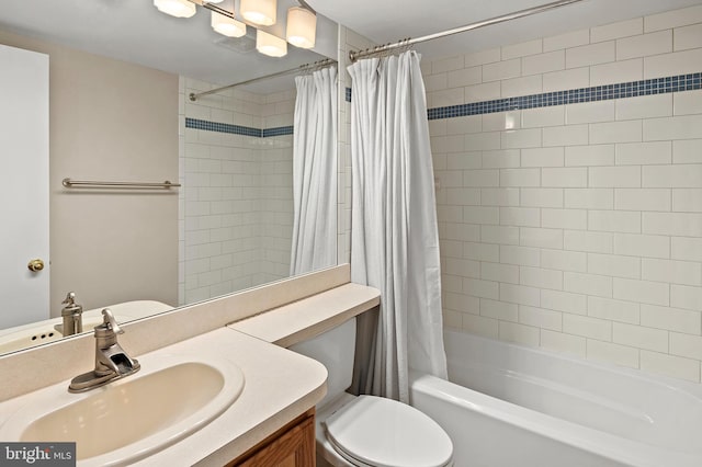 full bathroom with vanity, toilet, and shower / bath combo with shower curtain