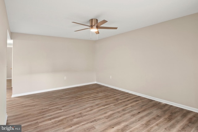 unfurnished room with ceiling fan and wood-type flooring