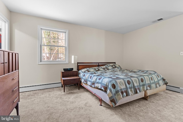 bedroom featuring baseboard heating and light colored carpet