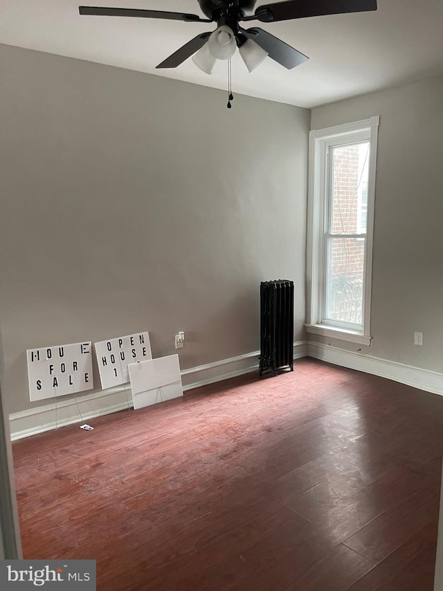 empty room with hardwood / wood-style flooring and ceiling fan