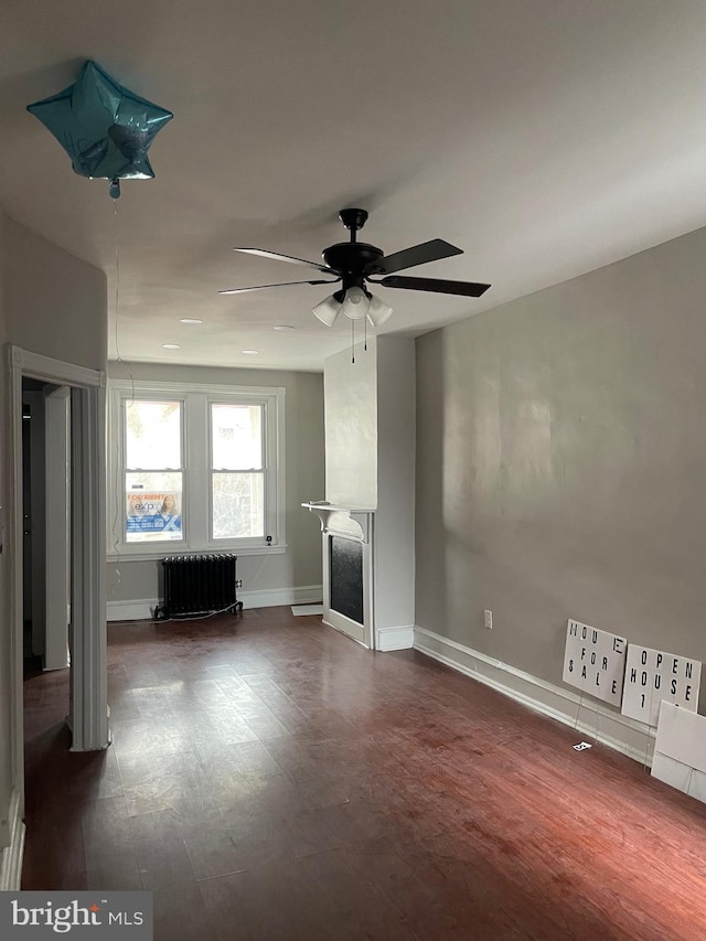 unfurnished living room with ceiling fan and radiator heating unit