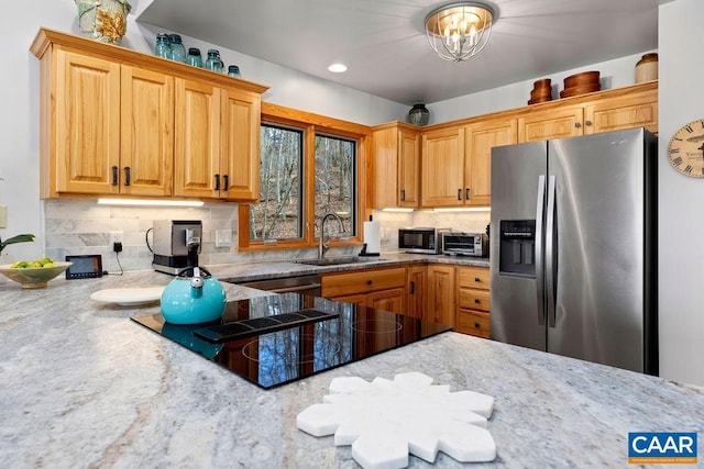 kitchen featuring tasteful backsplash, sink, stainless steel appliances, and an inviting chandelier