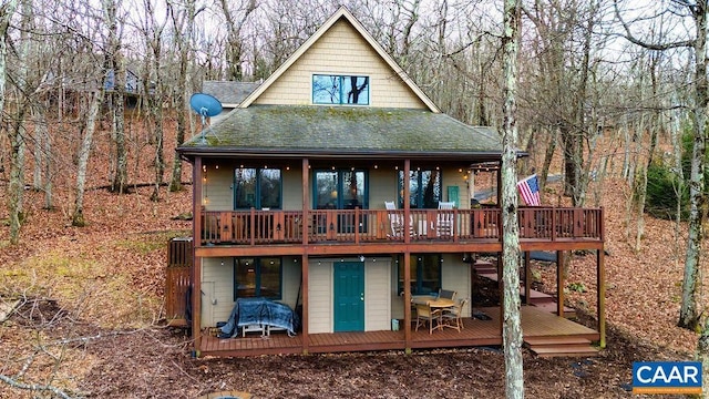 rear view of property featuring a deck