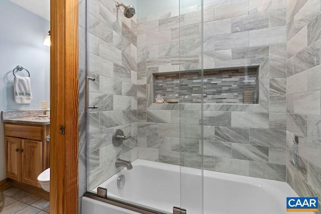 bathroom featuring tile patterned floors, vanity, and enclosed tub / shower combo