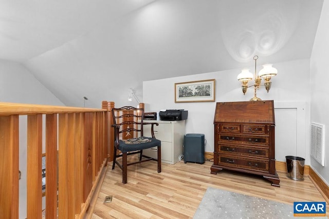 sitting room with light hardwood / wood-style floors, lofted ceiling, and an inviting chandelier