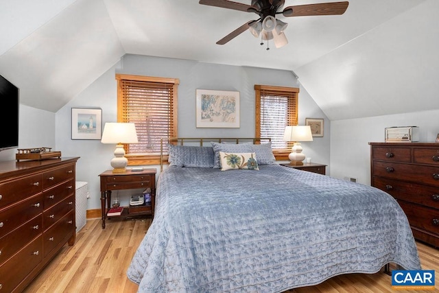 bedroom featuring ceiling fan, light hardwood / wood-style floors, and lofted ceiling