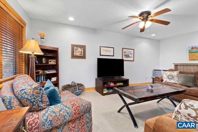 carpeted living room featuring ceiling fan