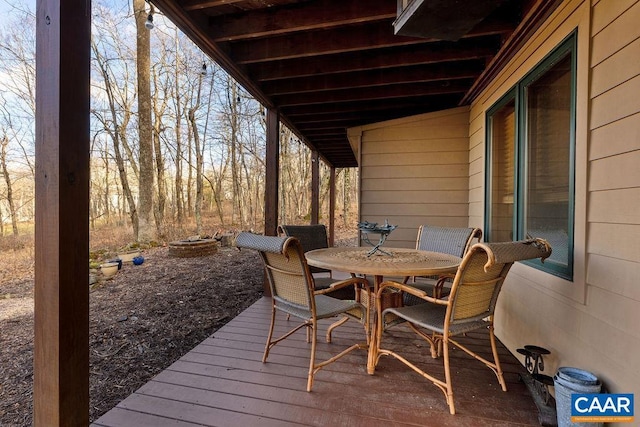 wooden terrace featuring a fire pit