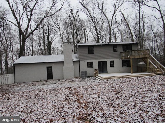 back of property with a deck and central air condition unit