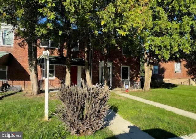 obstructed view of property featuring a front yard