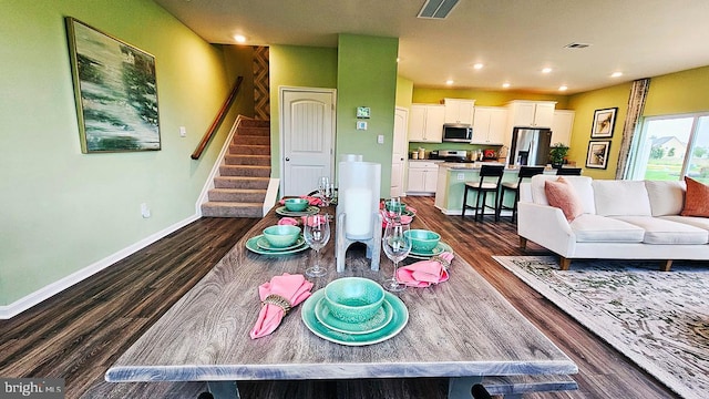 dining space featuring dark hardwood / wood-style floors