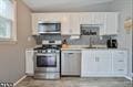 kitchen with stove and white cabinets