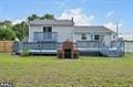 back of house with a yard and a wooden deck