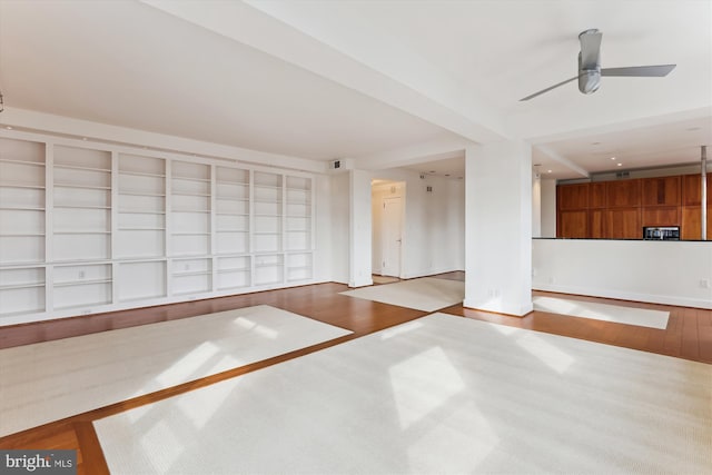 unfurnished living room with light wood-type flooring and ceiling fan