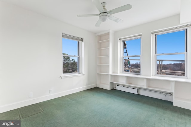 empty room featuring ceiling fan, dark carpet, and baseboard heating