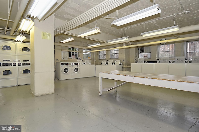 garage with washer and clothes dryer and stacked washer / drying machine