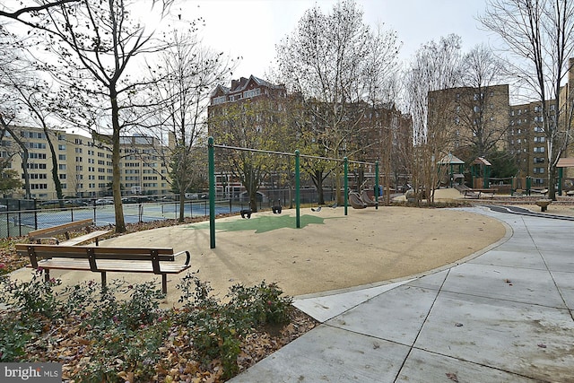 view of home's community with tennis court and a playground